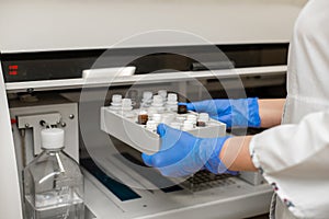 Laboratory technician test blood in automatic blood sample analyzer