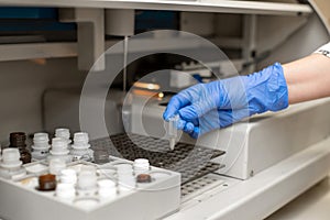 Laboratory technician test blood in automatic blood sample analyzer