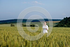 Laboratory-technician using digital tablet computer in a cultivated wheat field, application of modern technologies in