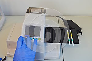 Laboratory technician working with test strips indicator paper