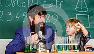 Laboratory test tubes and flasks with colored liquids father and son child at school. laboratory research and