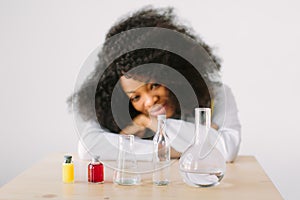 Laboratory work. Portrait of a young beautiful African American girl researcher chemistry student carrying out research