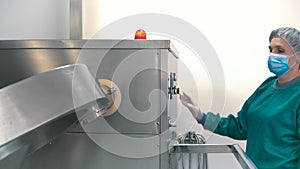 Laboratory worker adjust pharmaceutical machine for mixing powder and granules
