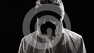 Laboratory worker in a chemical protection suit panting in front of the camera
