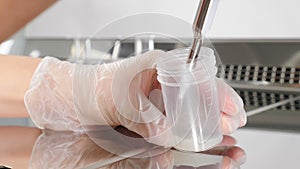 Laboratory worker in modern microbiology cabinet. Close-up of doctor working with semen sample. scientist embryologist