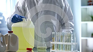 Laboratory worker studying biofuel for presence of sediment and additives