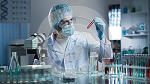 Laboratory worker studying blood samples to detect pathologies, medical research