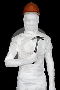 Laborer in bandages with helmet and hammer