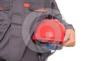 Laborer holding red hard hat in front of white background