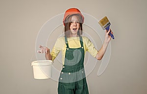 laborer kid wear safety hardhat. labor day. teen girl in uniform and helmet.