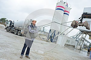 Laborer outside factory working dressed with safety overalls equipment