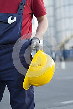 Laborer outside a factory working equipment