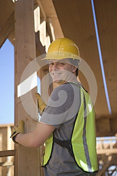 Laborer positioning plank of wood