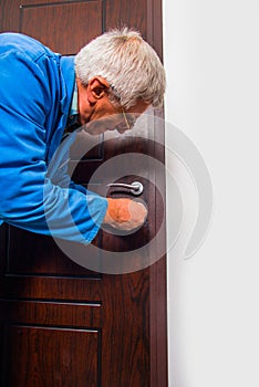 Laborer repairs the door in apartment