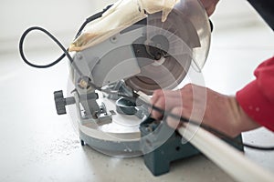 Laborer using a small electric circular saw