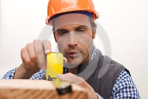 Laborer working with measuring tape