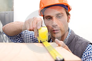 Laborer working with measuring tape