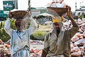 Laborers carrying rock salt