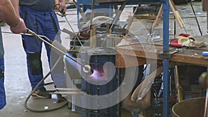 Laborers group heats form with gas burners flame in workshop