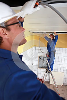 Laborers installing piping