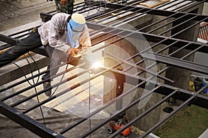 Laborers are making steel roofs painted black