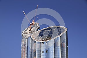 Laborers working on modern constraction site works in Dubai. Fast urban development concept