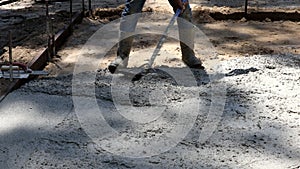 Labour builders construction workmen in the process of forming foundation concrete works with mixer truck with