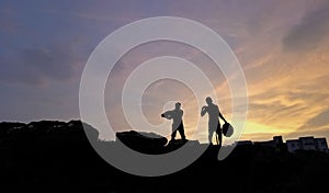 Labour civil worker silhouette image ,hard work, sun set , blue sky