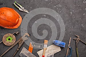 Labour day background concept - different construction tools on dark stone background with copy space