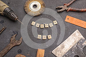 Labour day background concept - different construction tools on dark stone background