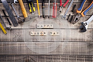 Labour Day, Wooden Block calendar with many handy tools on wooden background texture