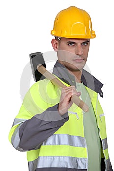 Labourer carrying a mallet