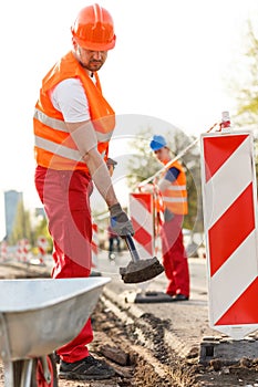 Labourer in orange safety helmet