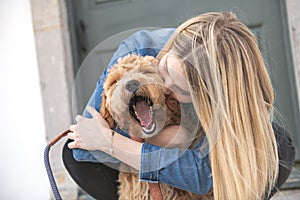 Labradoodle Dog and woman outside on balcony