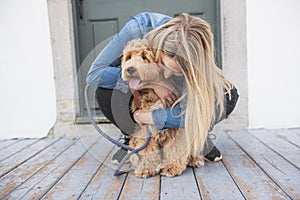 Labradoodle Dog and woman outside on balcony