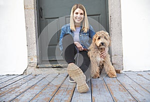 Labradoodle Dog and woman outside on balcony