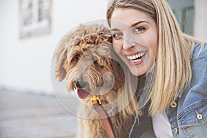 Labradoodle Dog and woman outside on balcony