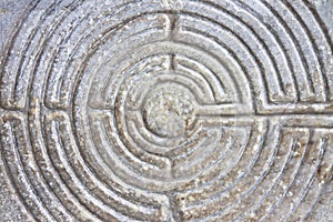 Labyrinth carved on the stone facade of a Romanesque church of the 11th century Tuscany - Italy