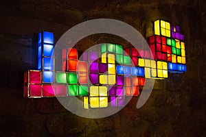 Labyrinth of colorful tile on wooden wall, tetris, side view