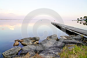 Lacanau lake with wooden pontoon in France in Travel and Vacation concept