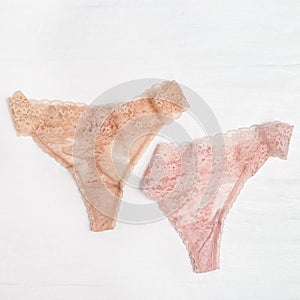 Lace bikini panties light pink colored. Women's lingerie on white background.