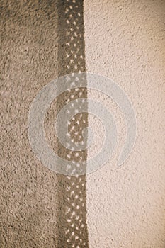 Lace curtains and their shadows. Sunlight falling on wall and creating shadow from curtains background.