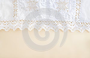 White lace with floral pattern on beige background