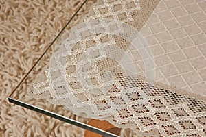 Lace tablecloth on a glass table