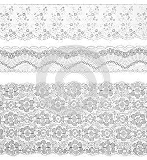 Lace trims ribbon over white. Set of fabric.