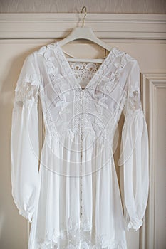 Lace wedding dress hanging on the closet