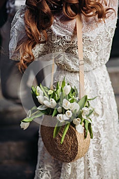 Lace white dress close up. Wattled handmade summer bags . Trendy natural eco bio accessory. Woman`s outfit concept.