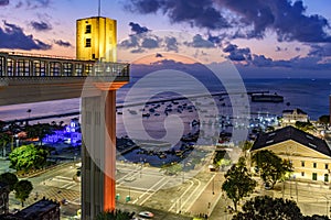 Lacerda elevator illuminated at dusk and with the sea and boats in the background