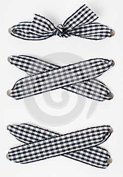 Lacing of black and white checkered ribbon