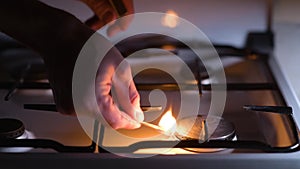 Lack of gas. A man is trying to light a match with gas on a gas stove